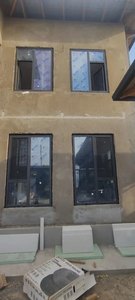 Customer and neighbours viewing 93 Series aluminium windows at a home project in Zafar, Tashkent